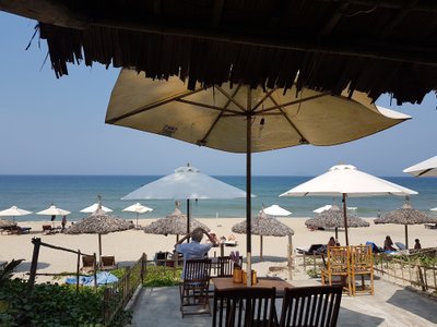 Chòi lợp lá của Lucky Beach Seafood Restaurant nhìn ra bãi biển và dù che nắng