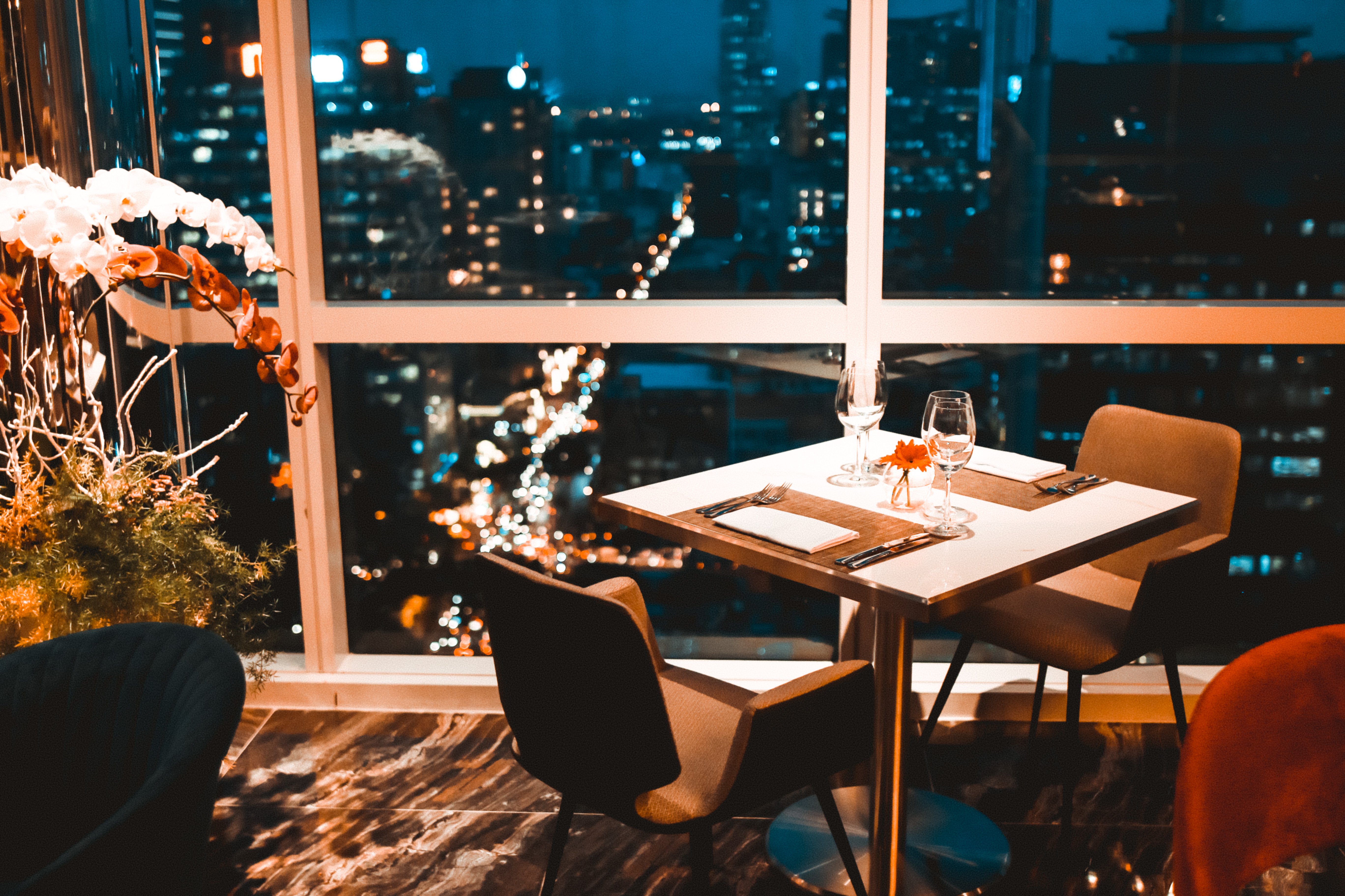 Bàn ăn hai người sát cửa kính nhìn xuống đường phố về đêm tại Shri Lifestyle Dining